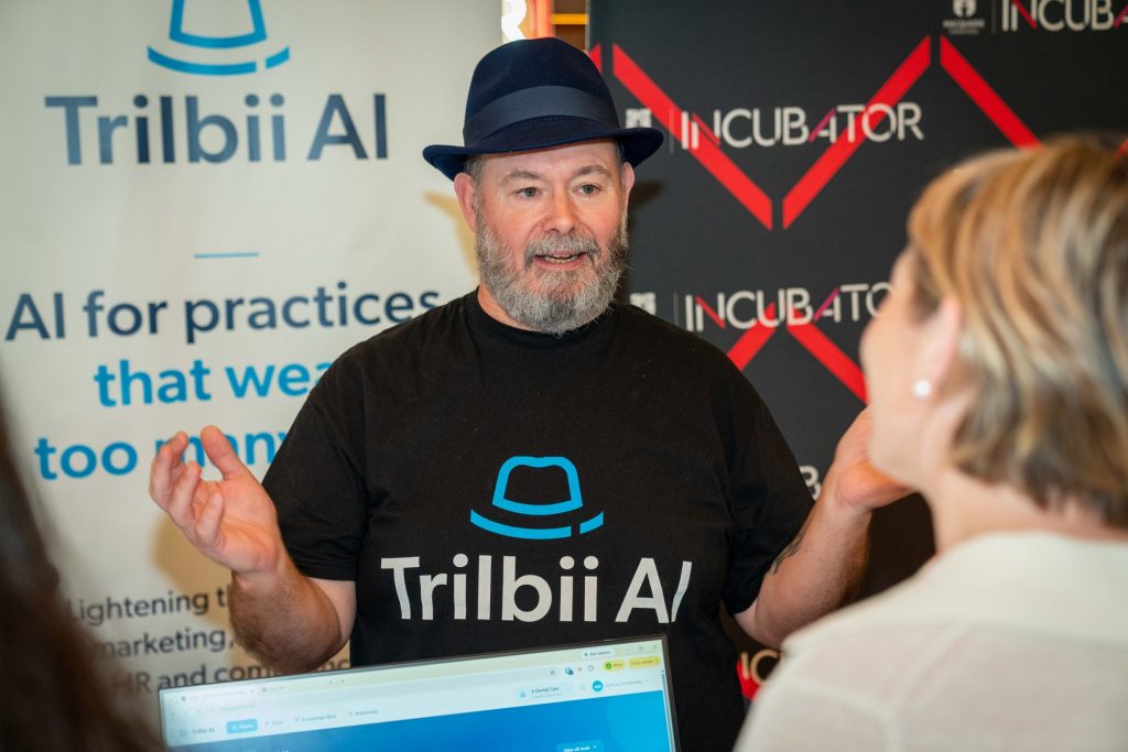 A member of the Trilbii AI team in conversation with an attendee at the Macquarie University Incubator Demo Day