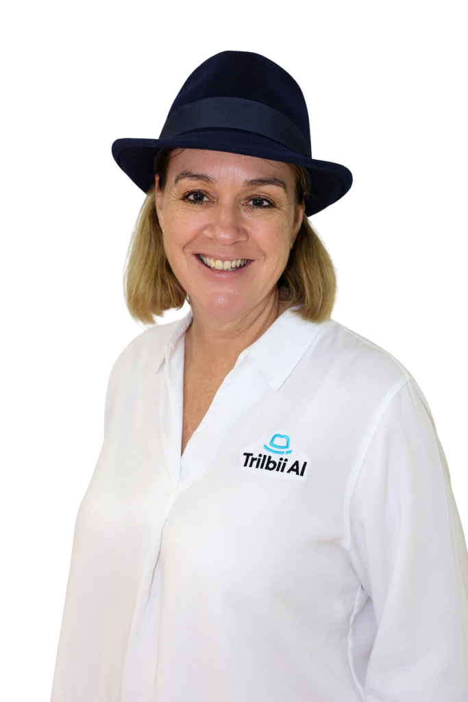 Carolyn S Dean, Founder and CEO of Trilbii AI, wearing a navy trilby hat and a white Trilbii AI shirt