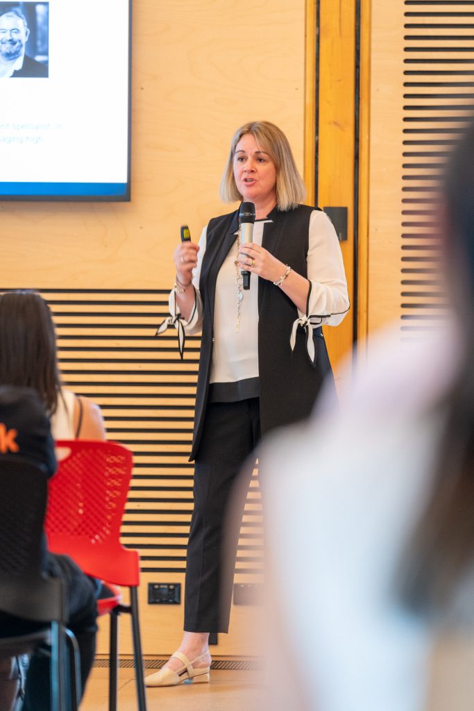Carolyn S Dean on stage at the Macquarie University Incubator Pitch Final 2025