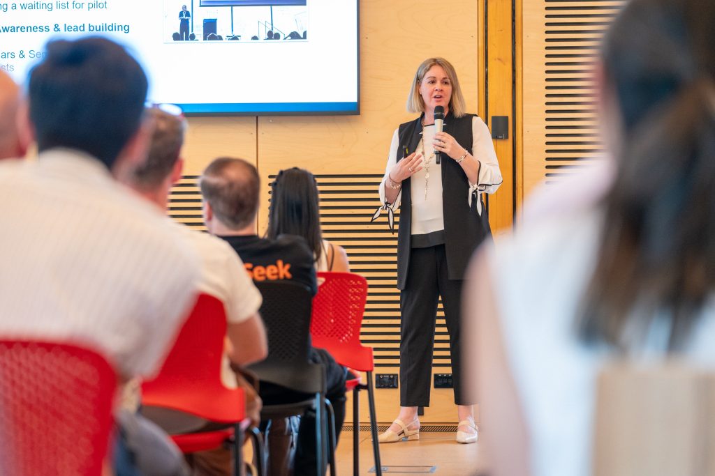Carolyn S Dean presenting the Trilbii AI pitch to the room at the Macquarie University Incubator